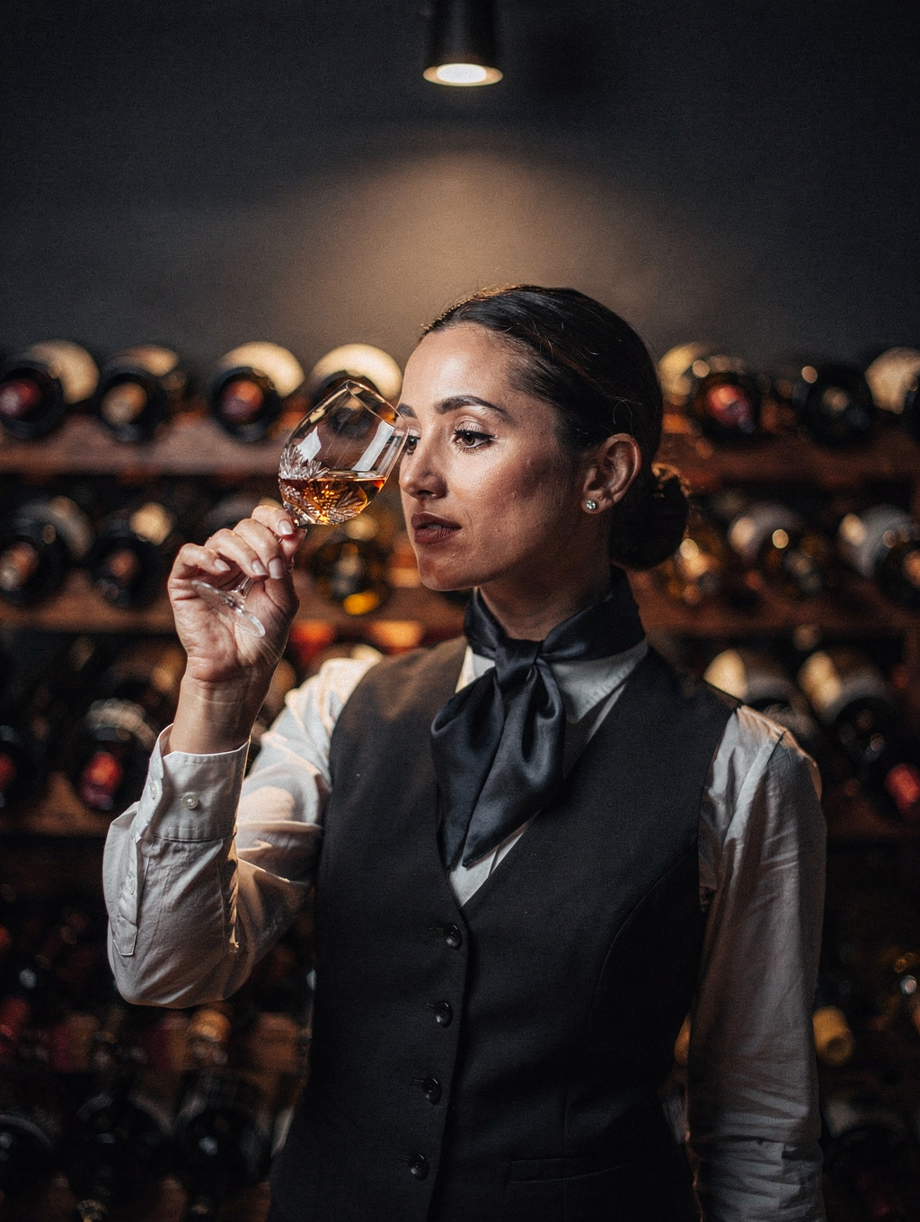 Sofia Bianchi selecting a vintage wine from the cellar